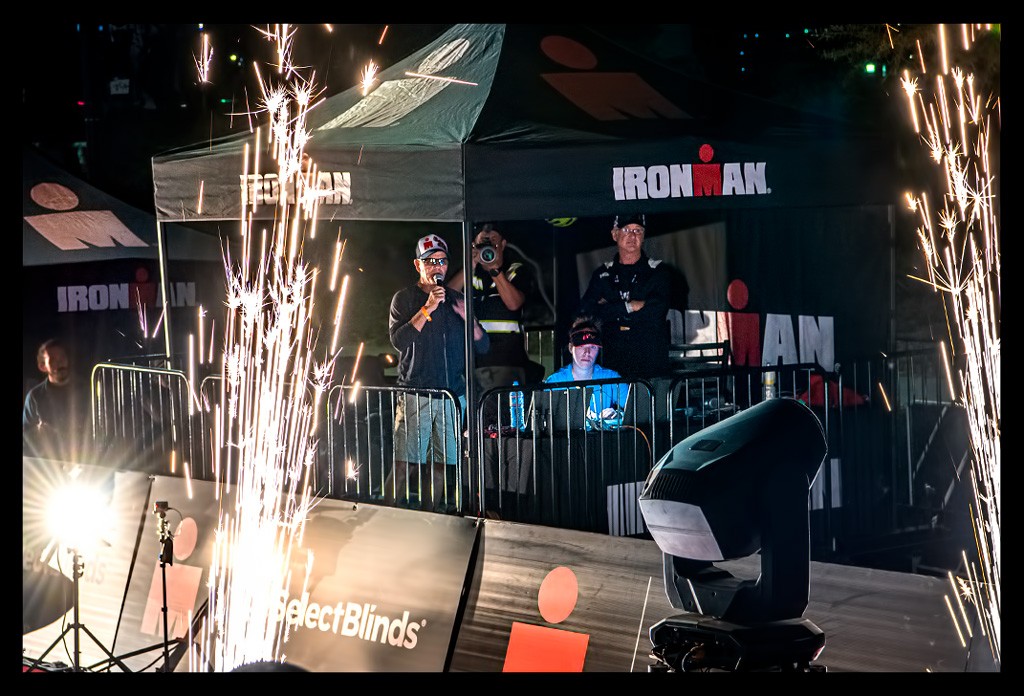 Ironman-Arizona-Tempe finishline with Mike Reilly on stage fireworks and flashlights red carpet "M" Logo Ironman