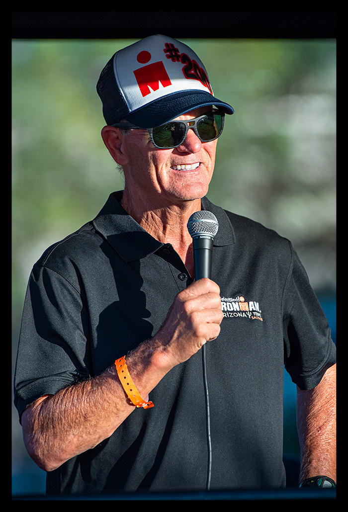 The Voice of IRONMAN  Mike Reilly Tempe Arizona Finish line with Sunglasses and microfon. black shirt and basecap with # 200 on it